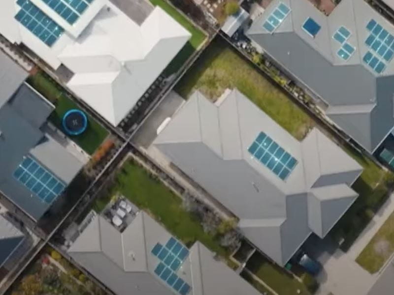 An aerial view portraying a residential neighbourhood with solar panels