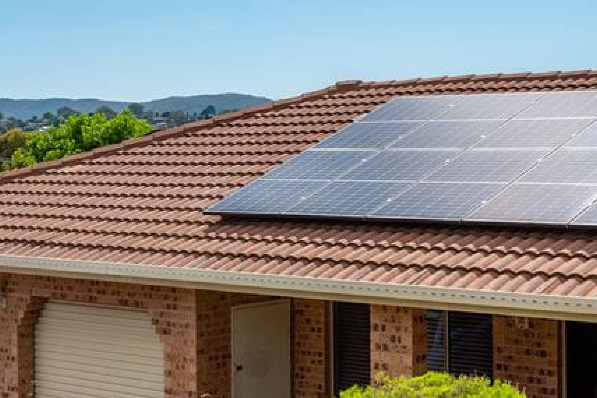 Red brick home with solar panels on the roof