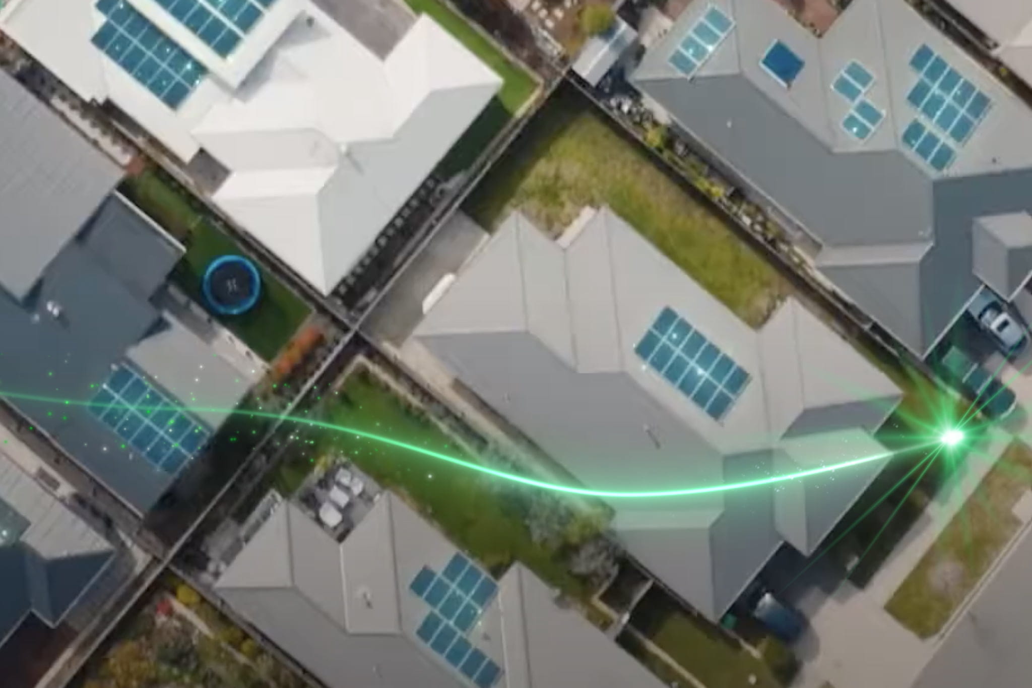 An aerial view of a suburb featuring solar panels on rooftops