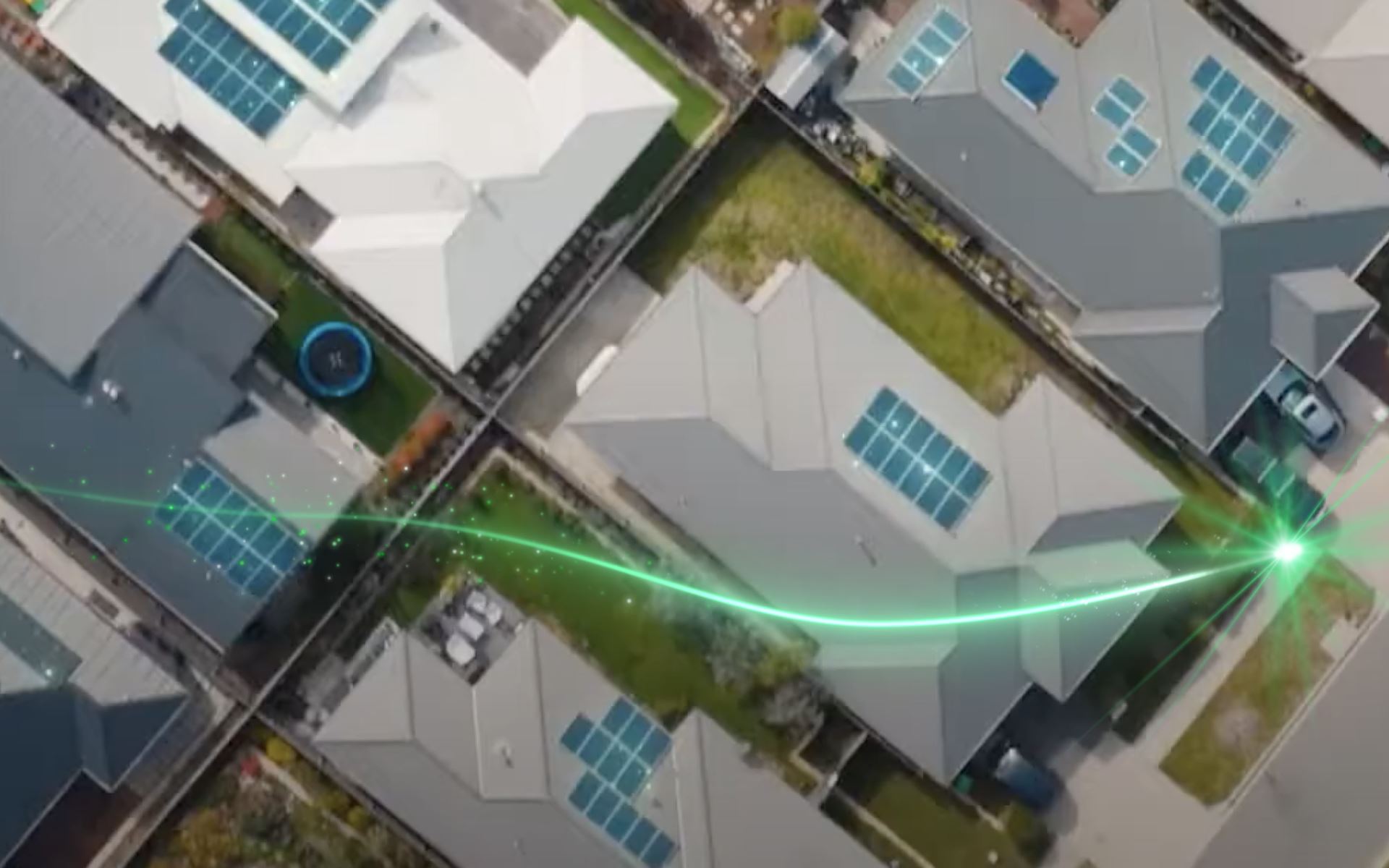 An aerial view portraying a residential neighbourhood with solar panels
