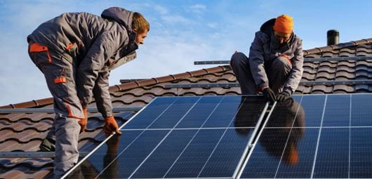 Tradesman installing a solar panel