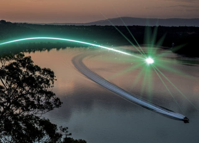 A lake surrounded by trees at dusk