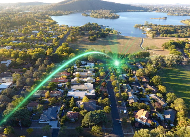 Aerial view of a city with a lake and a green light
