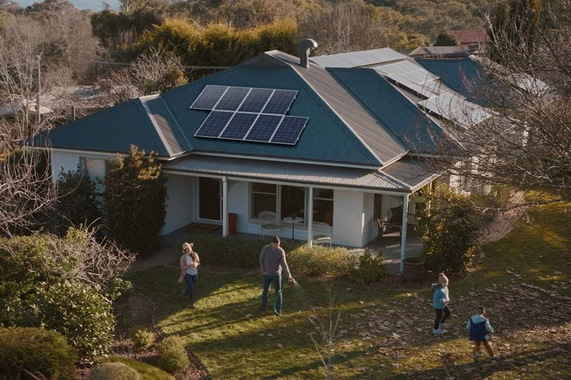 A home with a solar system and a family playing outside
