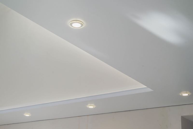 A white ceiling with lighting elements