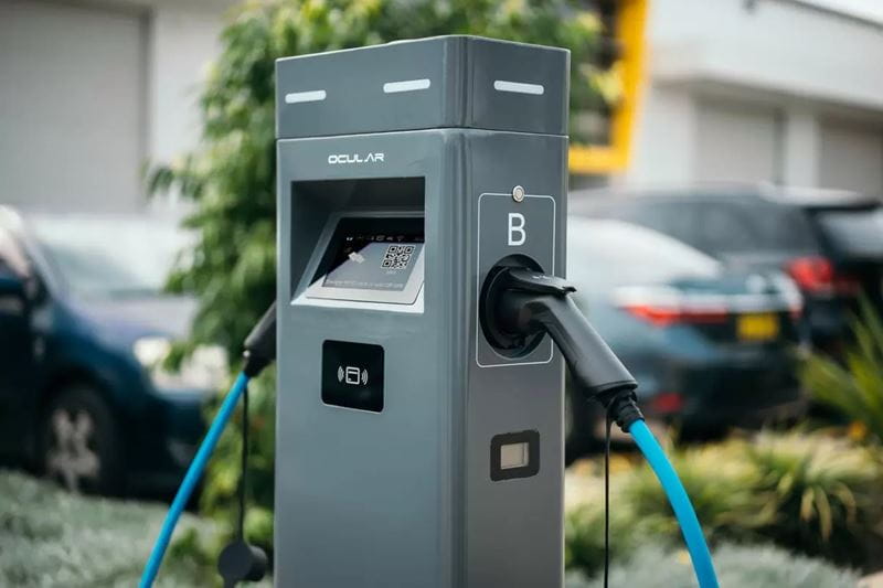 An EV charging station with two blue charging cables