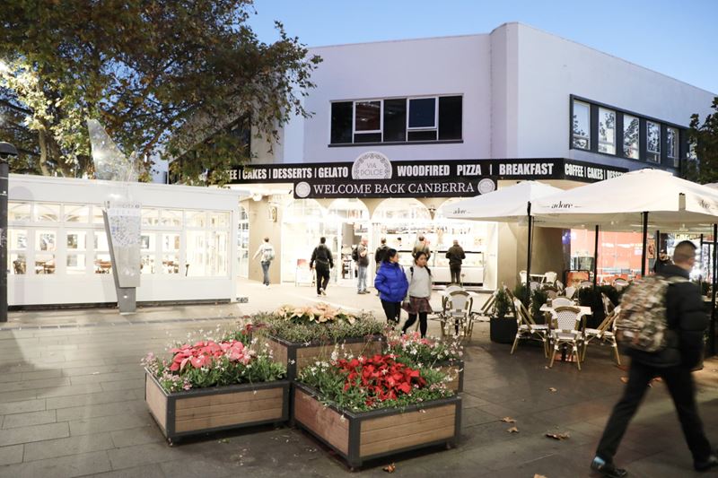 Flower bed in front of a white restaurant