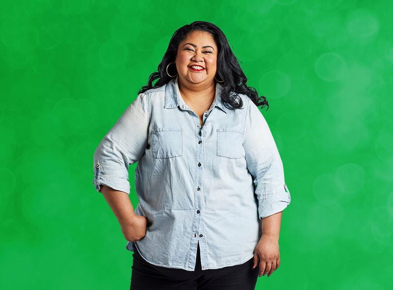Portrait of a woman against a bright green background