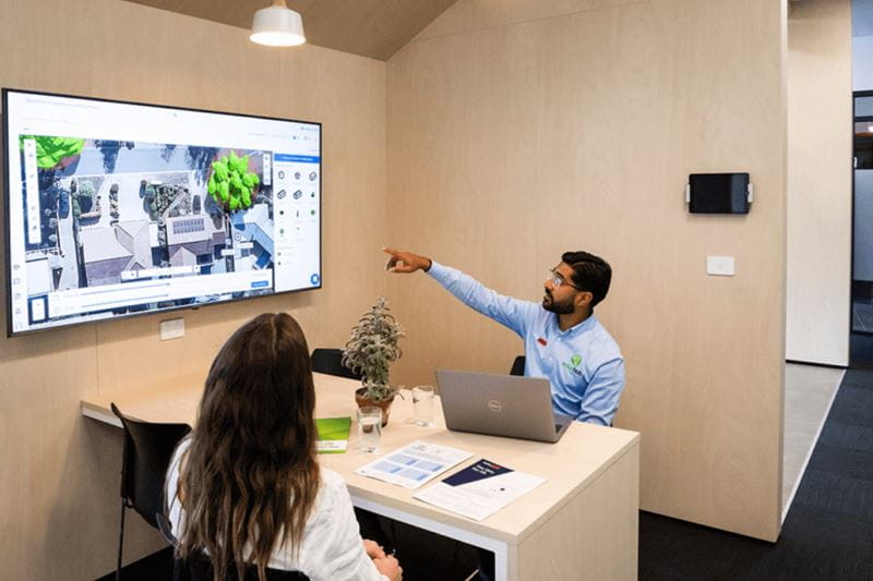 Smart Energy Hub team member guiding a customer through a home energy solution on a screen