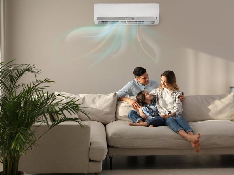 A family of three relaxing on a lounge with their child
