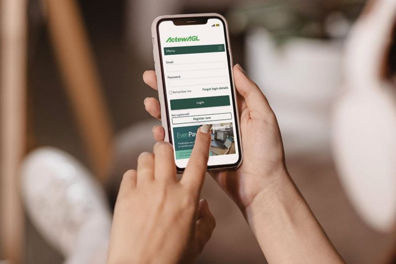 Hand holding mobile browsing on ActewAGL site
