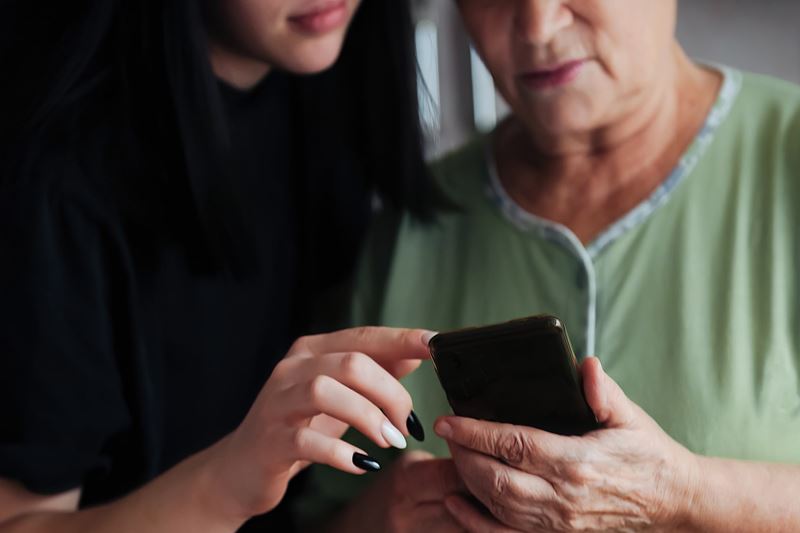 Two women looking at a mobile phone together