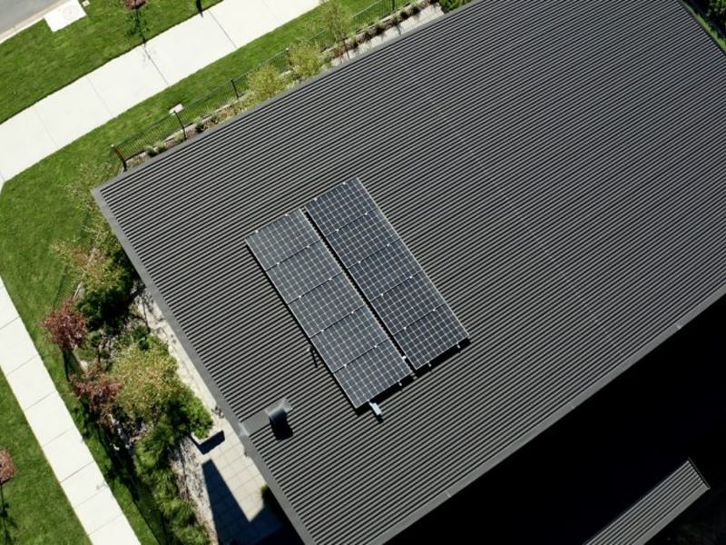 An energy efficient home with a solar panel on the roof