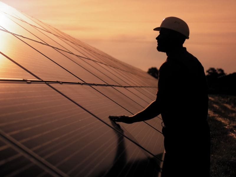 An energy engineer inspecting on solar panels