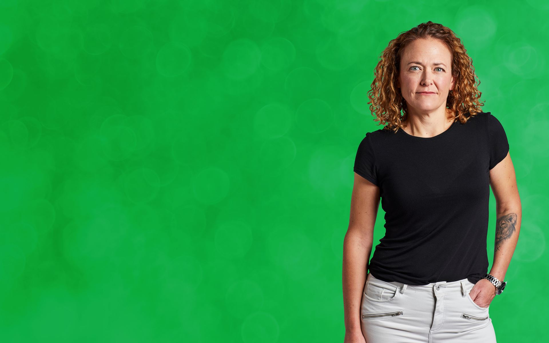 Woman standing against green background