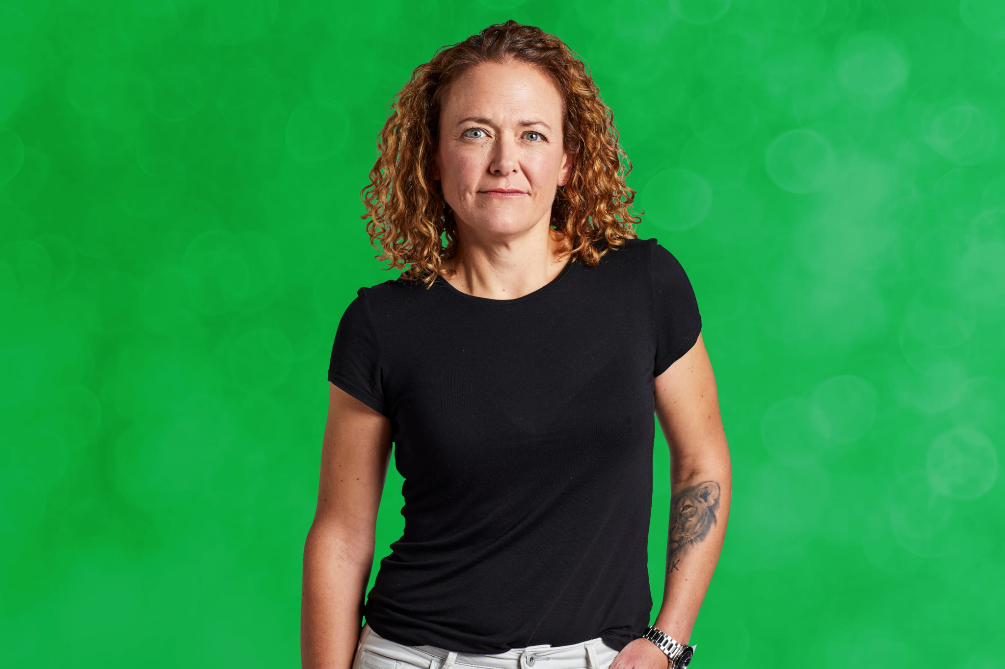 Woman standing against green background