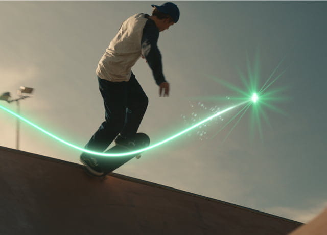 A young man riding his skateboard at a skate park