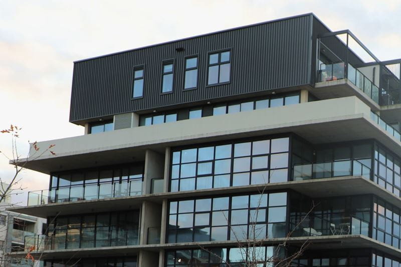 A large commercial building with a grey and black exterior