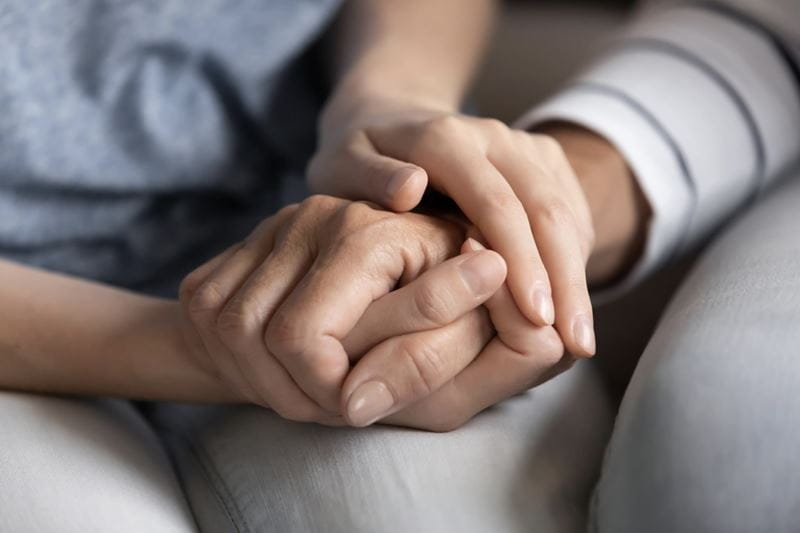 Two people holding hands 