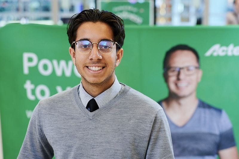 A man standing before an ActewAGL banner.